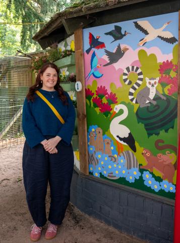 one of the artists standing beside their work 